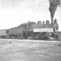 Black and white photograph of a train carrying first shipment of iron ore from the Kennedy Mine on the Cuyuna Iron Range, 1911. 