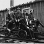 Taconite prospectors at Sulphur Camp, ca. 1916. To access Sulphur Camp, prospectors would have to take a rail cart, pictured here, from Mesaba Station. Seated to the far left is E. W. Davis.