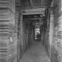 Black and white photograph showing stacks of milled lumber, ca. 1915.