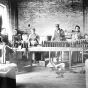 Black and white photograph of M. A. Gedney Company workers bottling product, c.1912.