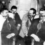 Black and white photograph of passengers with oxygen masks on Northwest Airlines plane, c.1940.