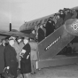 Black and white photograph of passengers boarding a Northwest Airlines plane, c.1946. Photographed by Philip C. Dittes.