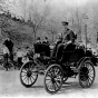 Black and white photograph of Swan Turnblad, ca. 1900 driving his Waverly automobile—the first commercially available car owned by a Minnesotan.