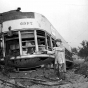 Black and white photograph of Minneapolis farewell to streetcars. TCRT Chairman, Fred A. Ossanna, smashes the window of an electric streetcar following the implementation of motor buses in Minneapolis, 1954.