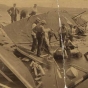 Black and white photograph of rescue workers searching for bodies in the wreckage of the Sea Wing, 1890. 