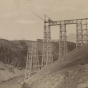 Black and white photograph of the Great Northern Railway trestle over Two Medicine in course of construction, ca. 1877. 