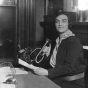 Black and white photograph of a woman in the office of the Jewish Family Welfare Association, Minneapolis, c.1925.