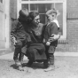 Black and white photograph of a woman with two boys at the Northeast Neighborhood House, c.1925. 