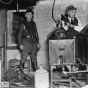 Black and white photograph of police destroying an illegal alcohol still during Prohibition, 1925. Photographed by the St. Paul Daily News.