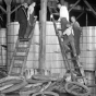 Black and white photograph of a group of people dismantling a still at Pillsbury and Charles Streets in St. Paul, c.1925.