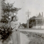 Black and white photograph of a woman and baby posing in front of the band shell in Hanover, ca. 1925–1930.