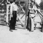 Black and white photograph of Harvey Fleshner with a Peterson farm employee outside the gates of the German prisoner of war camp, ca. 1943–1945.  Used with the permission of the Historical and Cultural Society of Clay County. 