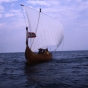 Color image of the Hjemkomst and crew on open water during their voyage to Norway, 1982. From the Tom Asp Collection, Historical and Cultural Society of Clay County.