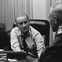 Black and white photograph of Vice President Humphrey discussing the Vietnam War with President Johnson and military officials, c.1965.