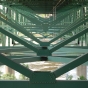 Underside of the bridge showing the deck truss construction and gusset plates. Photo by Flickr user ibran. BY-NC-ND 2.0