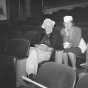 Black and white photograph of Charles and Louise Hiller sitting in theater seats, ca. 1940s.