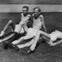 Black and white photograph of volunteers Gerald Wilsnack, Marshall Sutton, and Jasper Garner relax in the sun between their daily routine, c.1944.