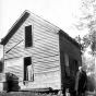 Frank B. Kellogg posed by the ruins of his old home in Olmsted County