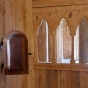 Color image of the leper’s window and part of the choir screen separating the chancel from the nave inside the Hopperstad Stave Church replica, April 2, 2017. Photographed by Kaci Johnson.