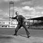 Black and white photograph of Minneapolis Mayor Hubert Humphrey throws out the first pitch of a baseball game played by the Minneapolis Millers at Nicollet Park in Minneapolis on April 27, 1948. 