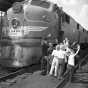 Black and white photograph of agroup of kids visiting a Milwaukee Road locomotive. Photograph by the Star Tribune Company, April 4, 1948.