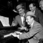 Black and white photograph of Jimmy Durante (back left) and Mayor Hubert H. Humphrey sing along with two unidentified men, 1946. 