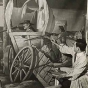 Black and white photograph of artist John Socha at work on a Works Progress Administration mural at the New Ulm High School, 1941. 