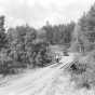 Car approaching a bridge with pedestrians along the Gunflint Trail. Photograph by William F. Roleff, 1936. 