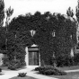 Black and white photograph of the he Round Tower covered in vegetation, c.1942. Photographed by Norton and Peel.