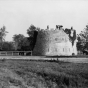 Black and white photograph of men and women with parasols standing atop the round tower, c.1900.