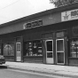 Black and white photograph of Businesses near the intersection of East 38th St and 4th Ave, Minneapolis, 1975.