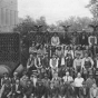 Black and white photograph of workers posed by Pillsbury “A” Mill in Minneapolis, ca. 1918. 