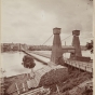 Black and white photograph of the Hennepin Bridge from Nicollet Island, c.1868.