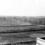 Black and white photograph of fans lining the fields for football games at The Parade, about 1923.