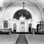 Black and white photograph of the interior of the sanctuary in St. Mary’s Orthodox Cathedral, Minneapolis with an icon screen and banners, c.1906. 
