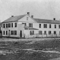 Black and white photograph of the Central House (where the Territorial Legislature met prior to the building of the State Capitol) and First State Capitol, St. Paul, ca. 1850.