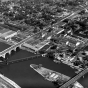 Black and white aerial view of the Flats, 1953, showing Robert, Wabasha, and railroad bridges and American Hoist and Derrick facilities.