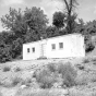 Black and white photograph of boxcar chapel in Swede Hollow, 1949.