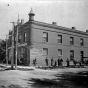 Black and white image of the Office of Faribault Woolen Mills, founder Carl H. Klemer standing to right of bicycle, 1897.