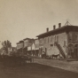 Black and white photograph of Division Street, Northfield 1870. The First National Bank is the first door to the left of the staircase. Photographed by Sumner’s Gallery.  