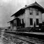 Black and white photograph of the first train depot, built by the Merritts at Mountain Iron, 1893.