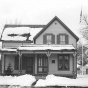 Black and white photograph of Sinclair Lewis’ childhood home, December 1975. Photographed by Henry Harren.