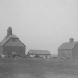 Black and white photograph of farm buildings at the State School, 1905.