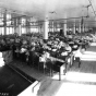photograph of a room full of women at sewing machines