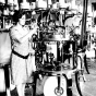 photograph of a woman operating a Munsingwear knitting machine