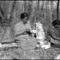 Photograph of Mary Bigwind and Maggie Skinaway making birch bark containers for maple sap