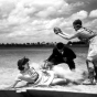 All American Girls Professional Baseball League player Marg Callaghan sliding into home plate as umpire Norris Ward watches (Opalocka, Florida)