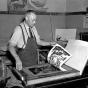 Black and white photograph of a lithographer at work, 1938.