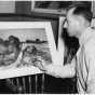 Black and white photograph of Cameron Booth posing with a watercolor, 1937.