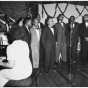 The Wheatley Aires, a men’s singing group, sing in front of an audience at Phyllis Wheatley Community Center (809 Aldrich Avenue North) with a pianist accompanying. ca. 1950.
